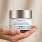 Hand holding SkinCeuticals Triple Lipid Restore jar