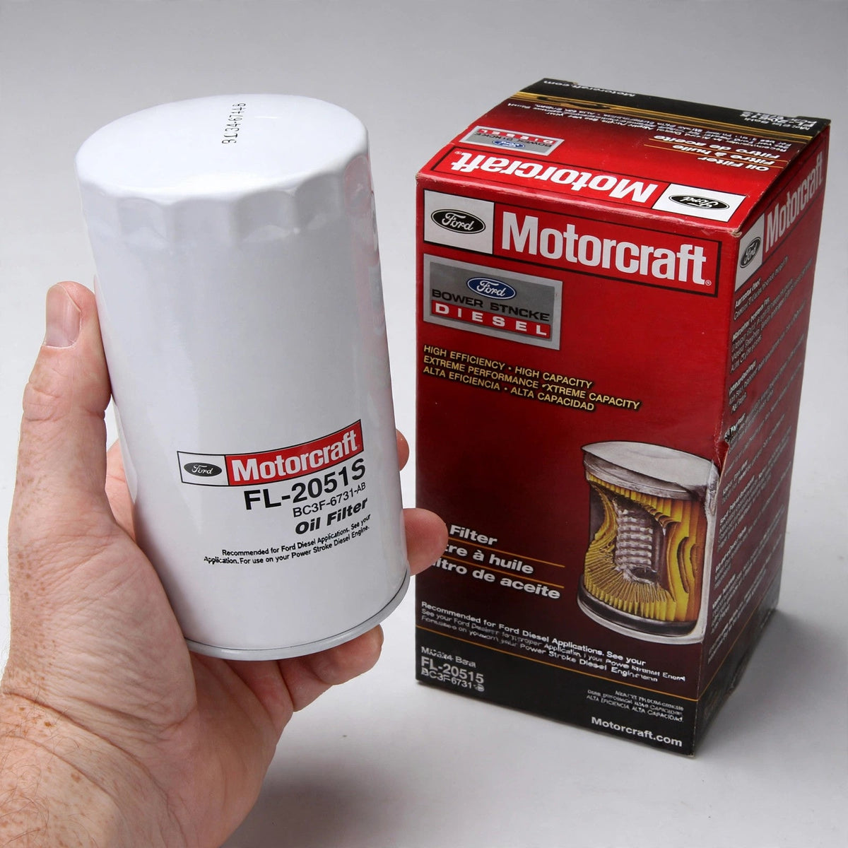 Hand holding a Motorcraft FL-2051S oil filter