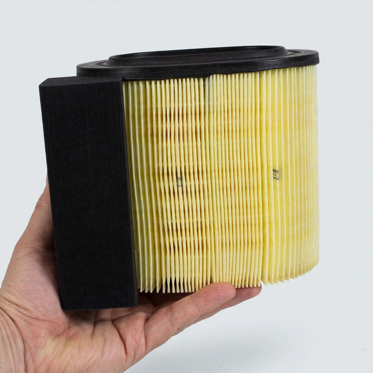 Hand holding a Motorcraft FA-1927 engine air filter