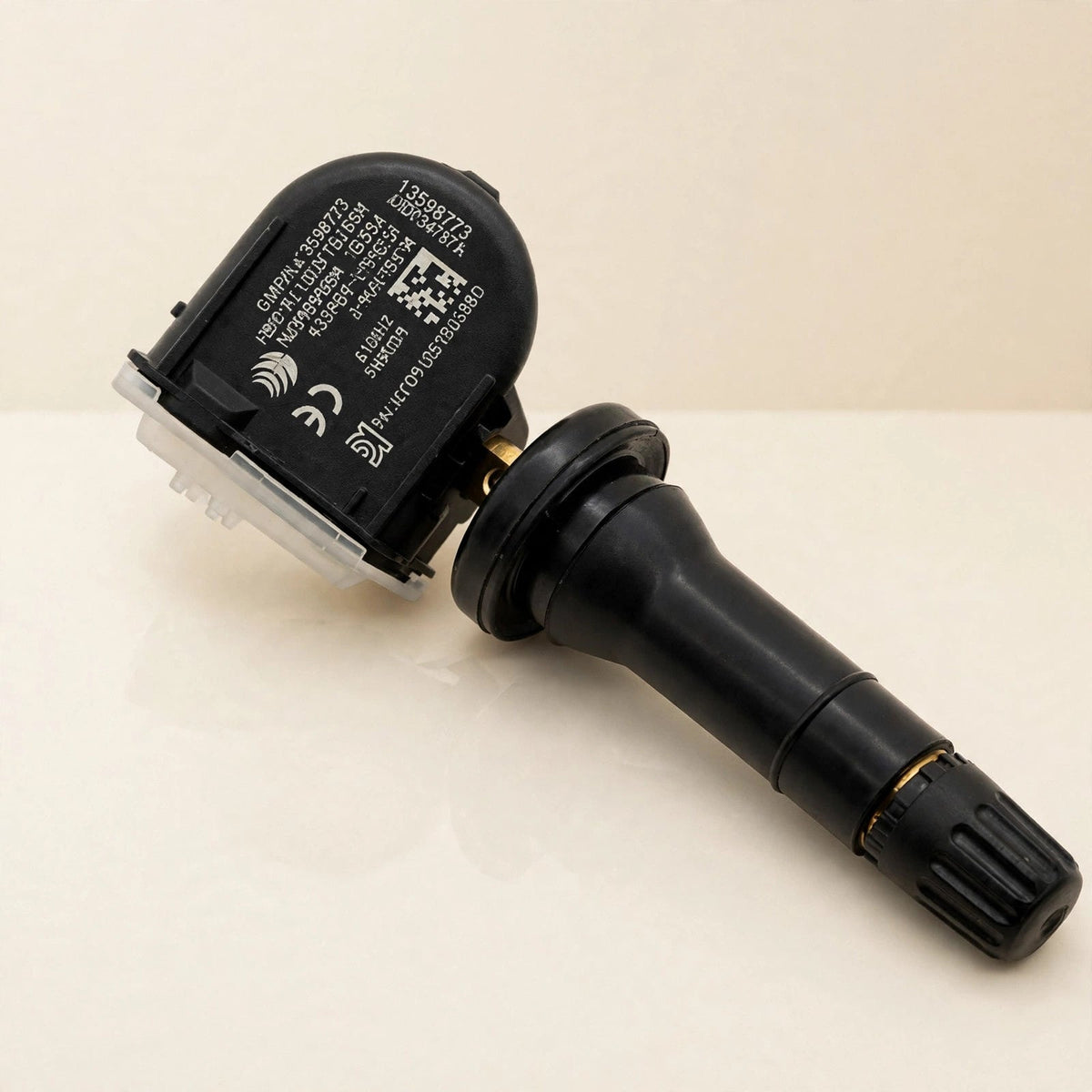 13598773 TPMS tire pressure sensor in a cream studio setting